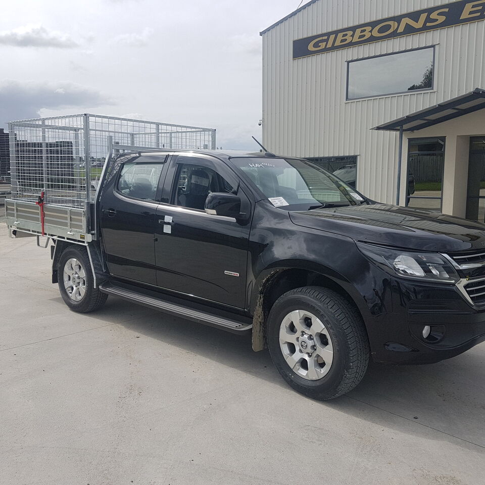 Black dual cab ute fitted with a custom aluminium tray and mesh cage system manufactured by Gibbons Engineering.