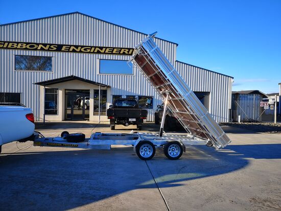 Tandem axle hydraulic tipping trailer raised outside the Gibbons Engineering workshop.