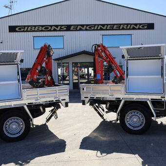 Twin crane truck setups with custom aluminium tray bodies manufactured by Gibbons Engineering for lifting and transport applications.