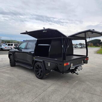 Custom black service body canopy with gullwing side doors built by Gibbons Engineering for trade and mobile workshop storage.