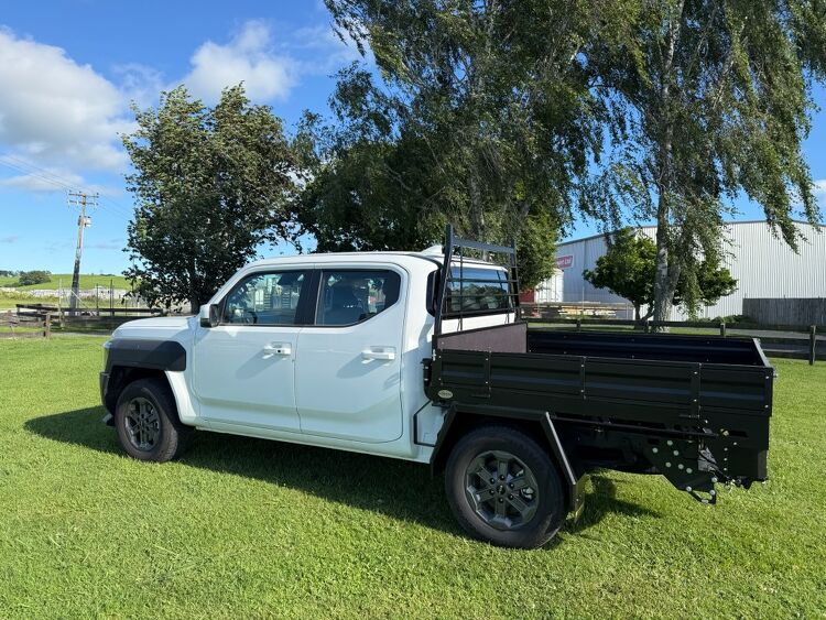 Black steel ute tray with side panels custom built by Gibbons Engineering on a white utility vehicle.