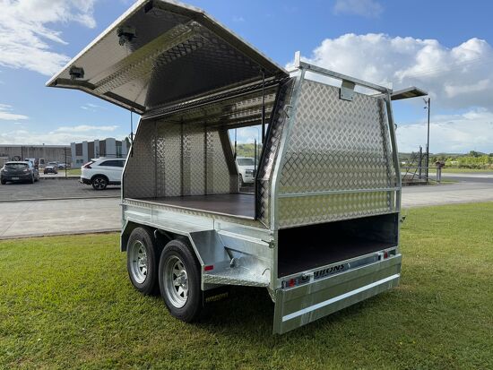 Rear view of a galvanised tandem axle canopy trailer with open gullwing roof access.